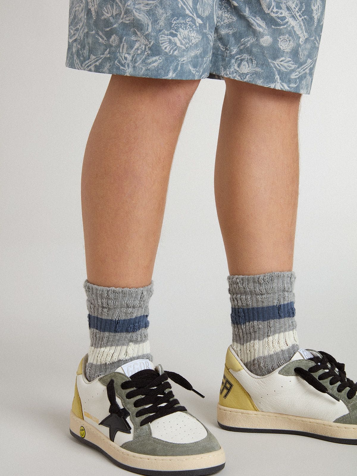 Golden Goose Kids’ gray socks with distressed details and worn-white and blue stripes