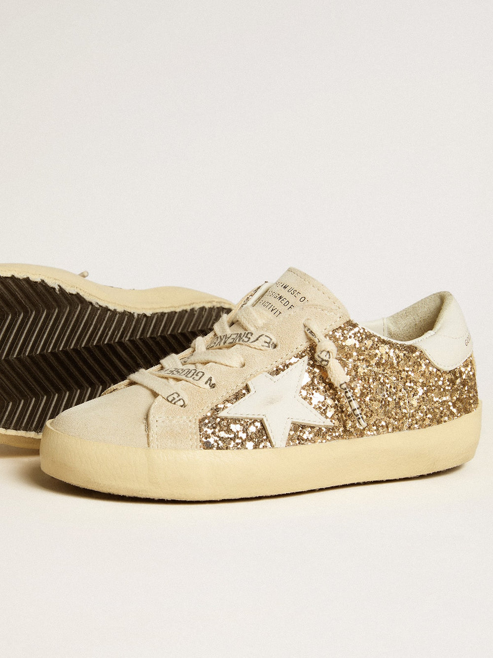 Golden Goose Super-Star Junior in gold glitter with white leather star and heel tab