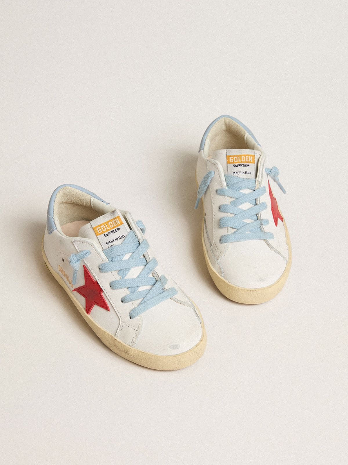 Golden Goose Super-Star Young in white leather with red star and light blue heel tab